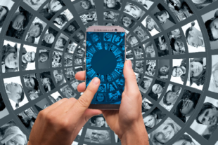 Man's hands on mobile phone with background showing circular grid of human faces.